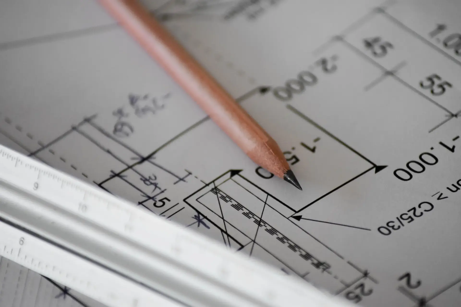 Pencil and ruler on an architectural blueprint